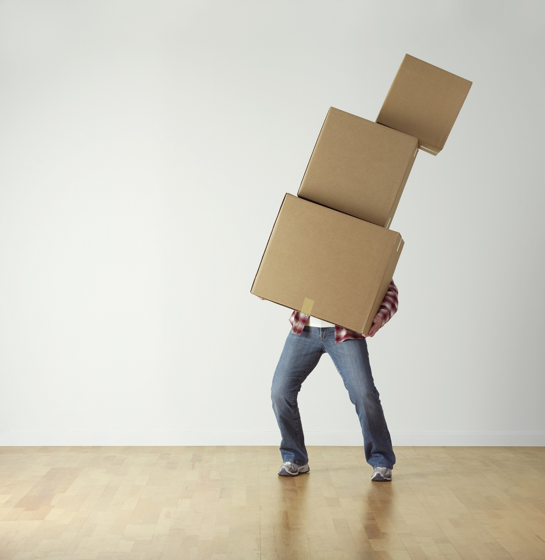 man holding 3 moving boxes