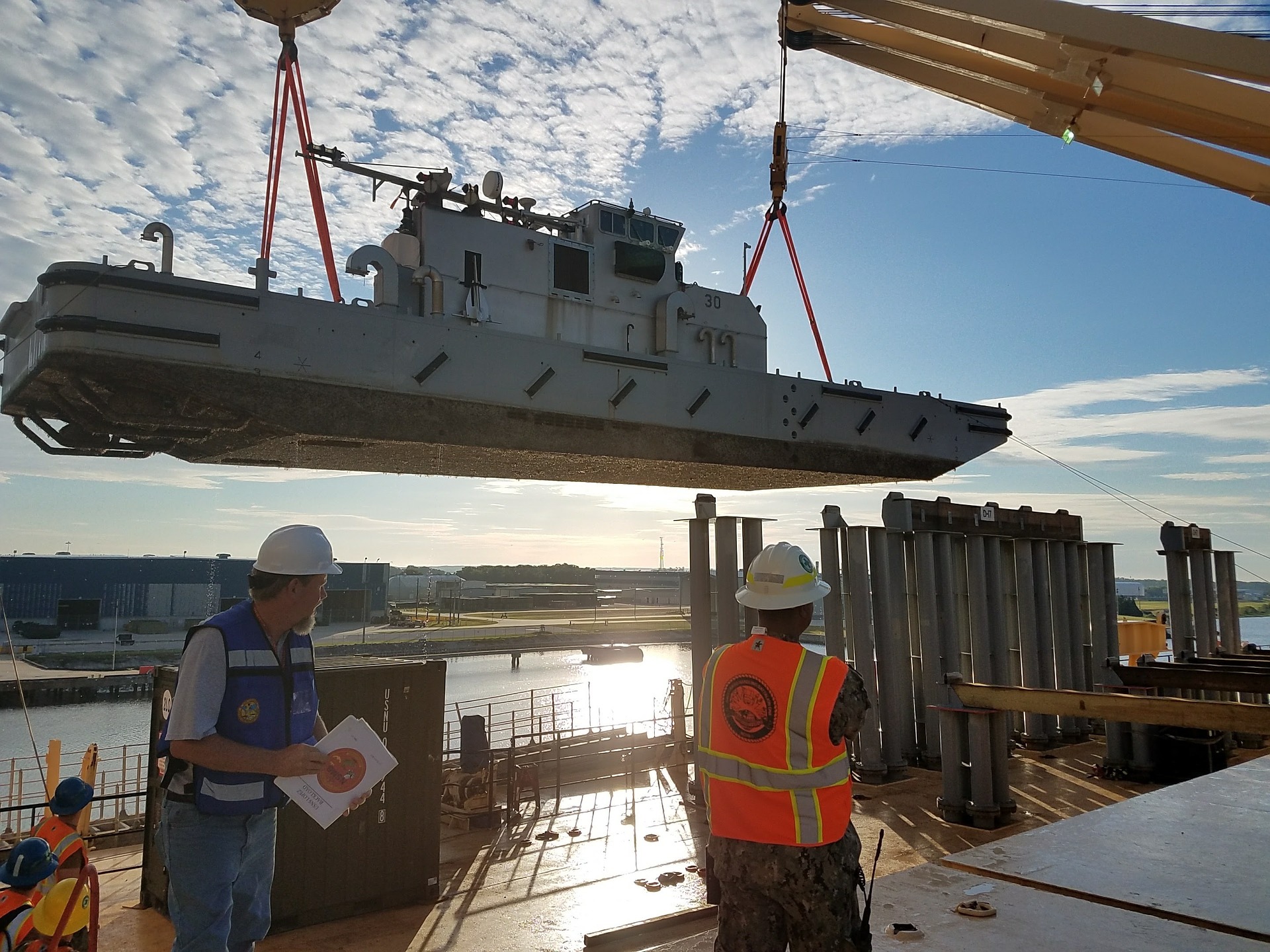 crane supervisor guiding boat loading