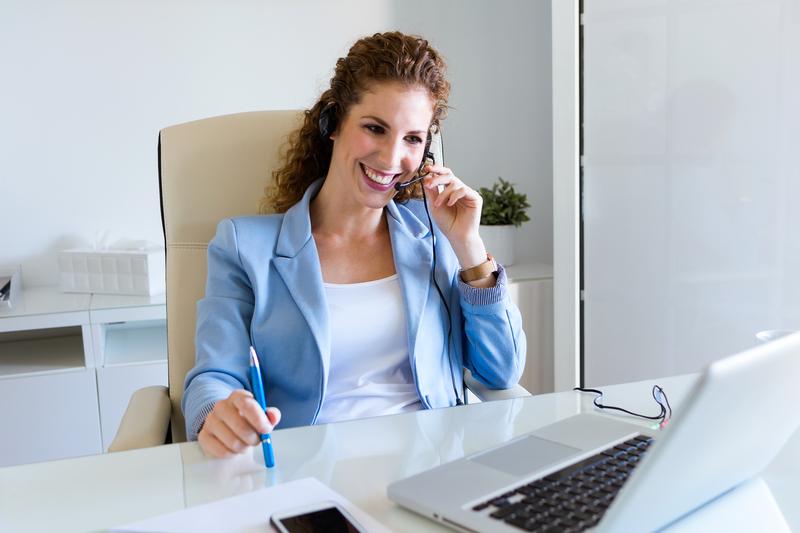 a woman standing in front of a computer