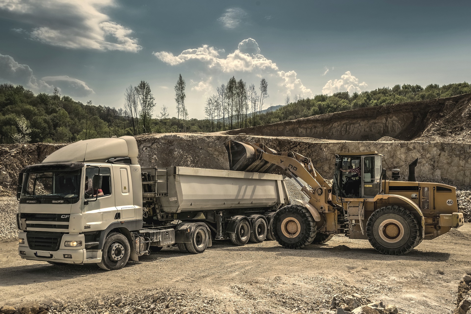 excavator loading semi truck