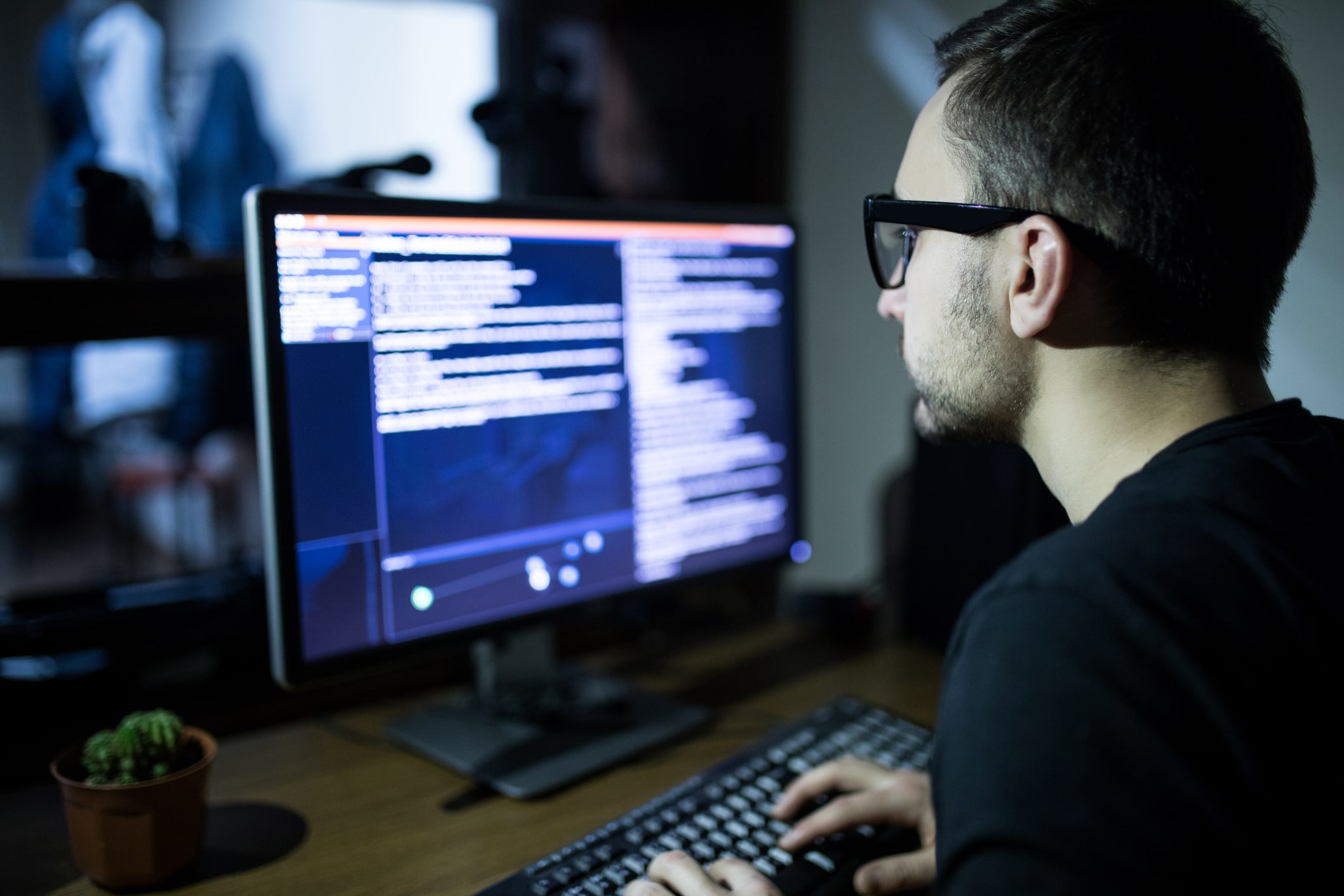 hacker sitting in front of computer