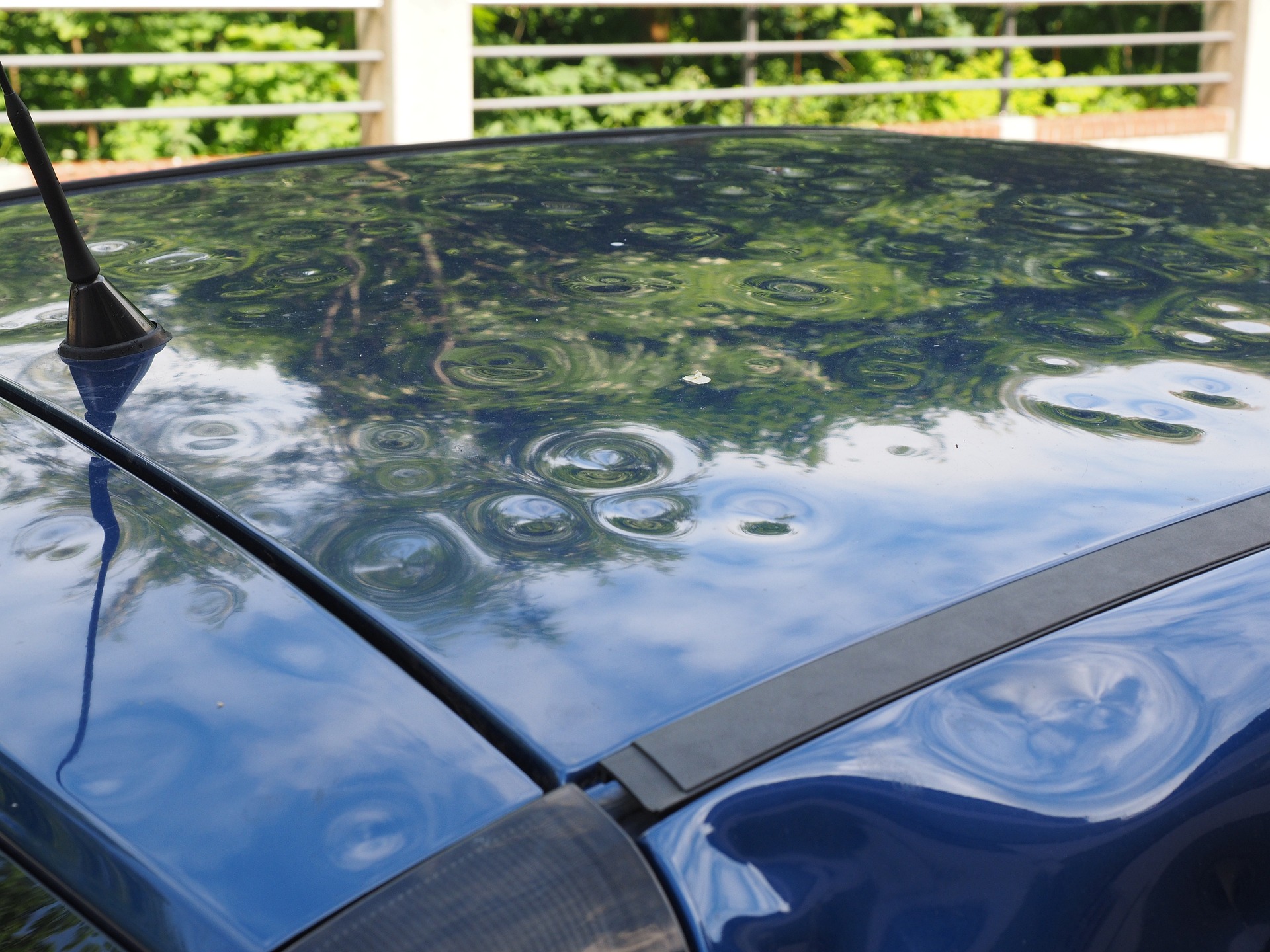 An image of a hood of a car that has been severely damaged by hail