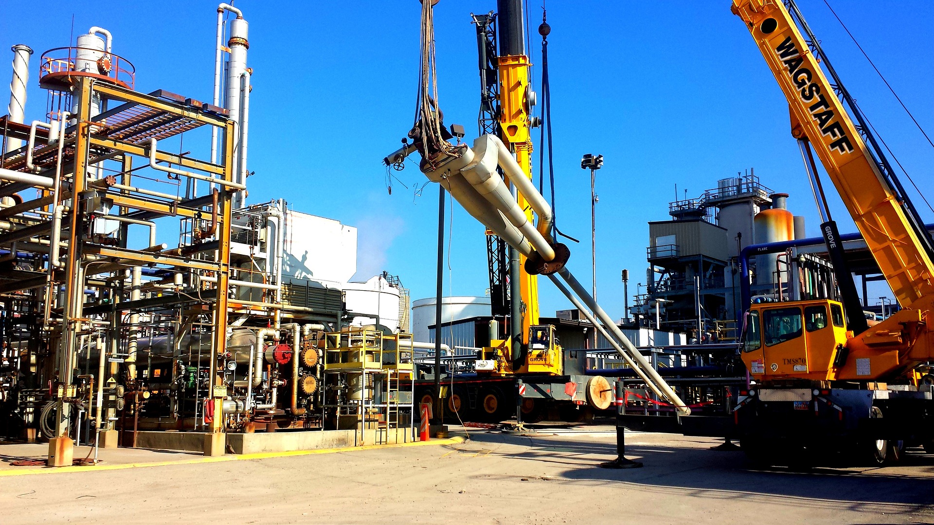 An image of a crane lifting oil and gas machinery