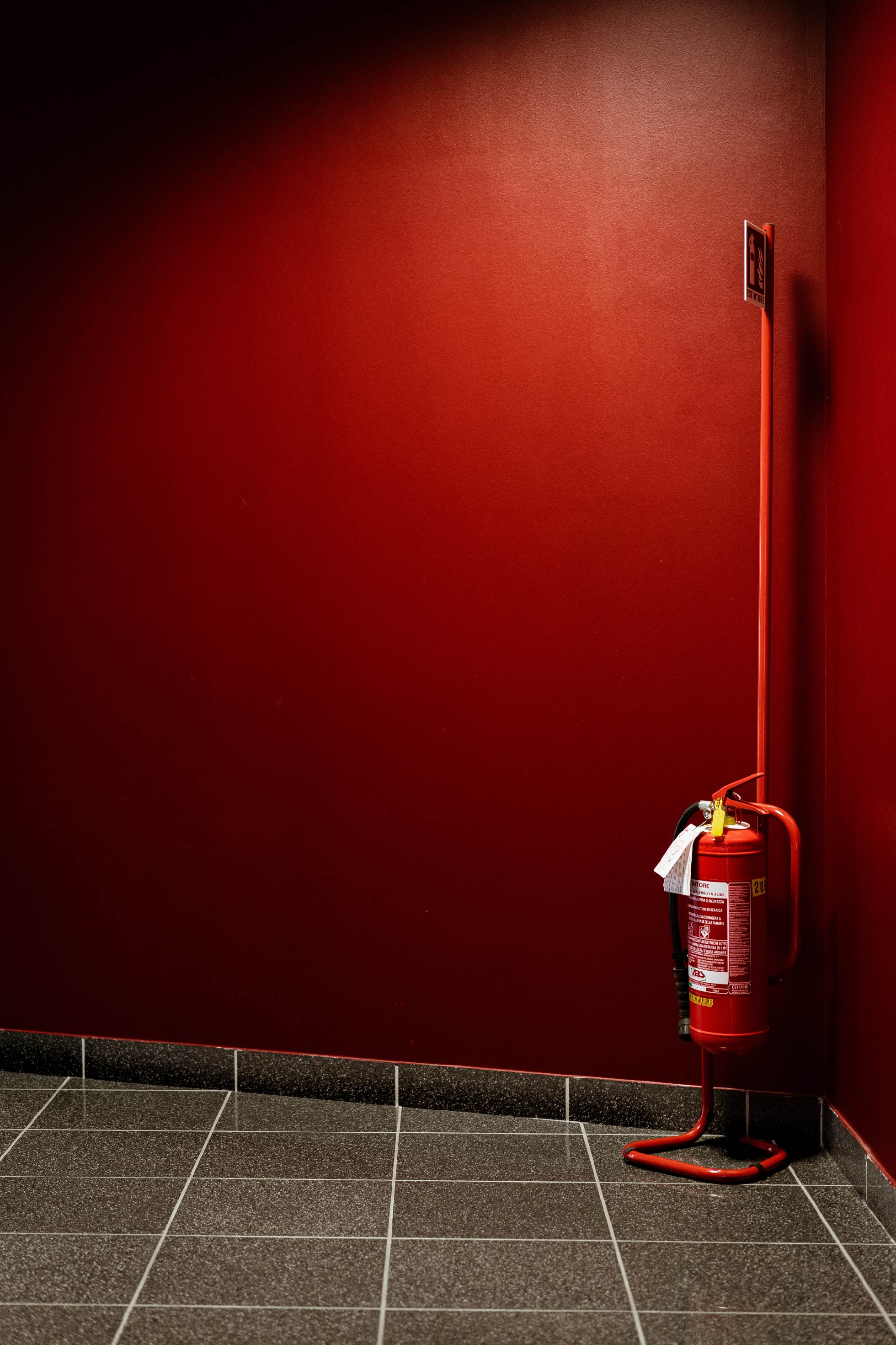 red fire hydrant next to wall