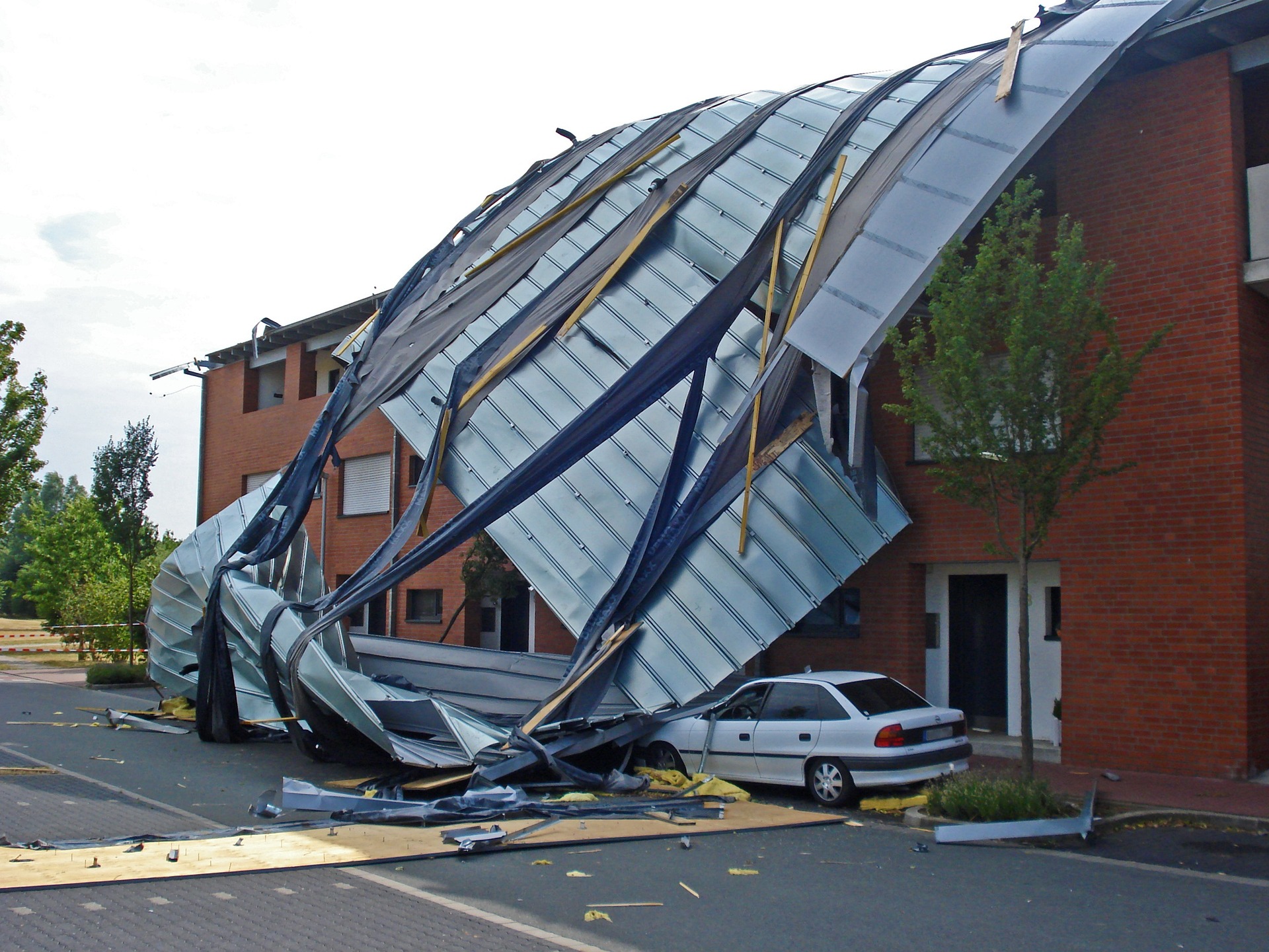 A commercial building that had the roof collapse on top of a car