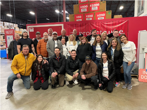 An image of a group of coworkers posing for the camera after volunteering