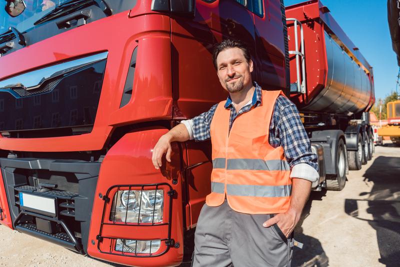 truck driver standing next to tanker