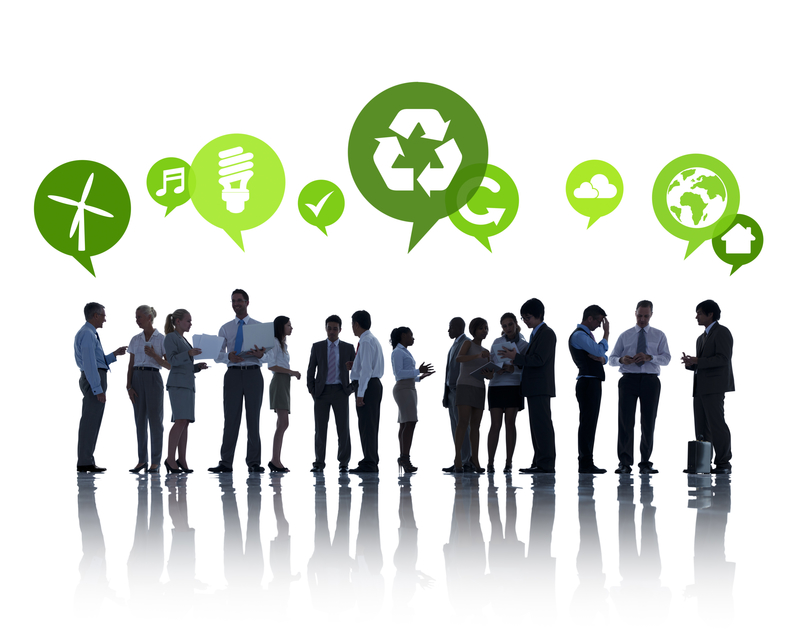 Group of professionals standing near recycle signs