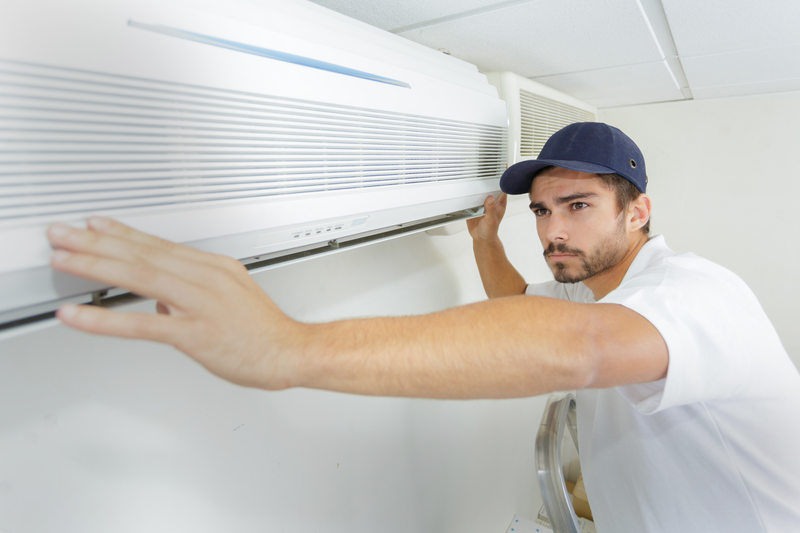 man working on hvac system