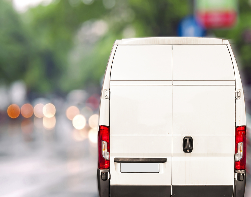 white commercial vehicle on the road