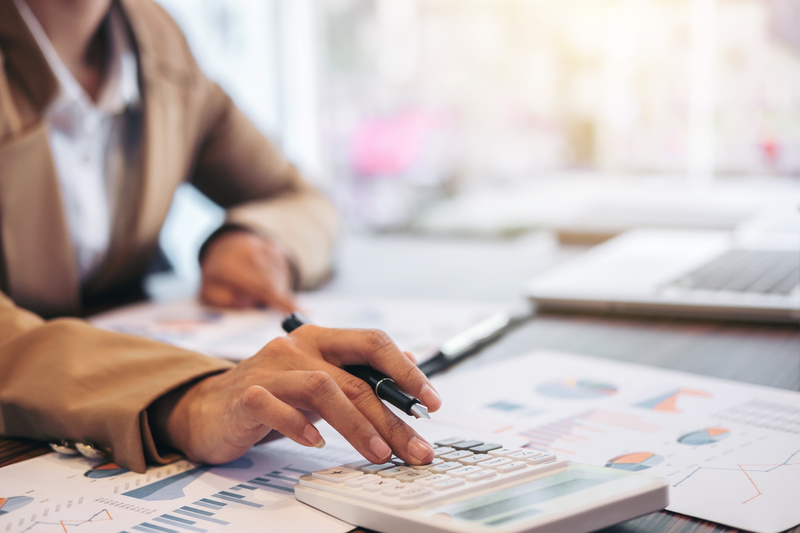 woman using calculator for reports