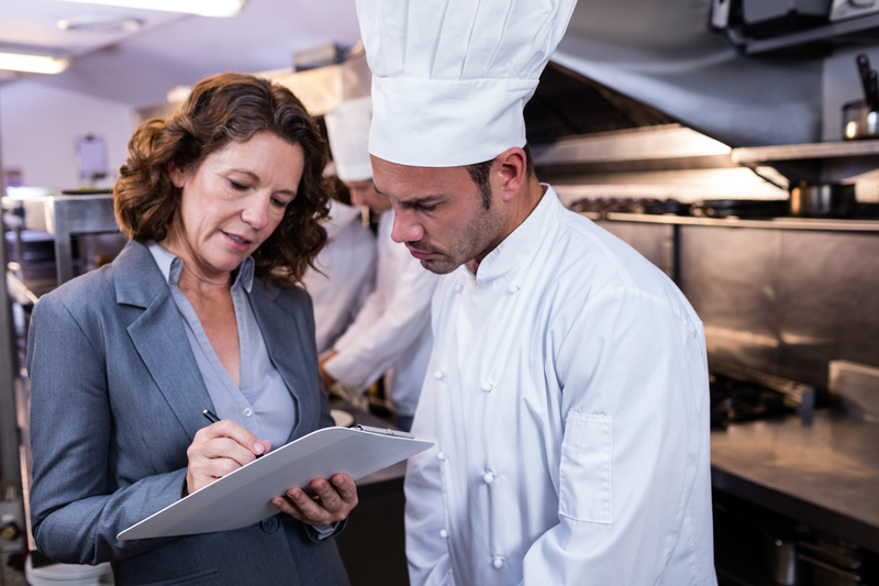 chef standing with inspector