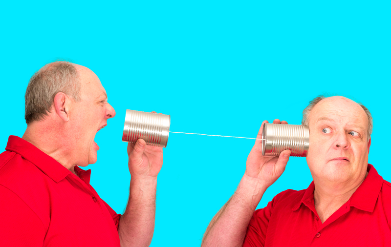man using cup phone to talk to himself