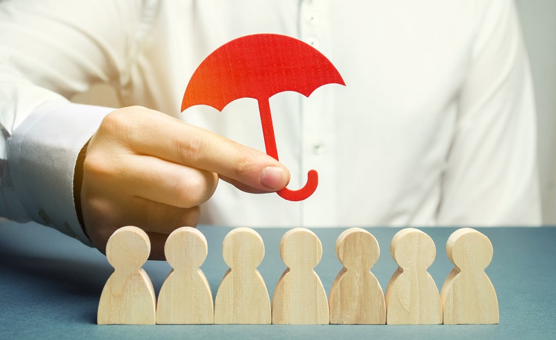 Umbrella over wooden people