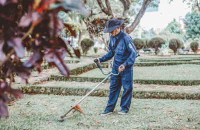 man working on lawn with landscaping equipment